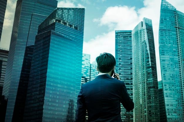 A businessman speaking on the phone with CallApp in front of office buildings