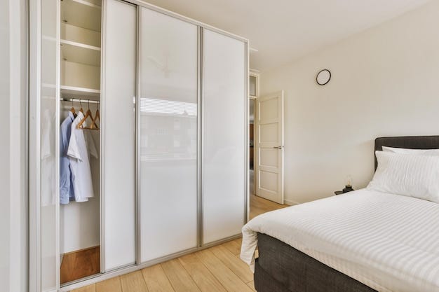 light bedroom with wooden sliding wardrobe