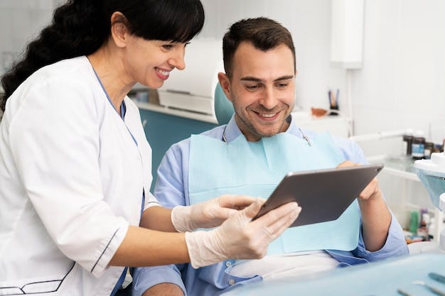 Dentist doing a check up on the patient and see them Dental Professional POrtal In the Image