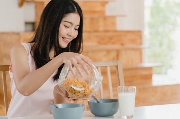 A girl serving herself breakfast