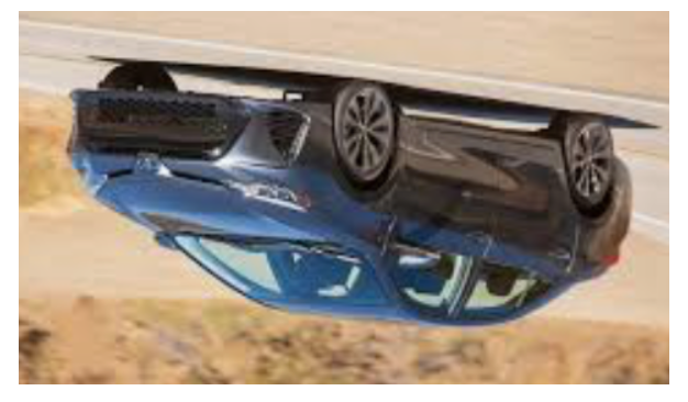 Upside down image of a Toyota Corolla being driven on the road.