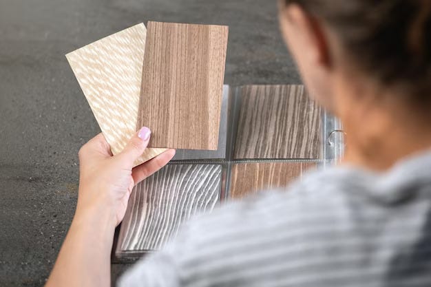 A man choosing between 2 luxury vinyl tile designs