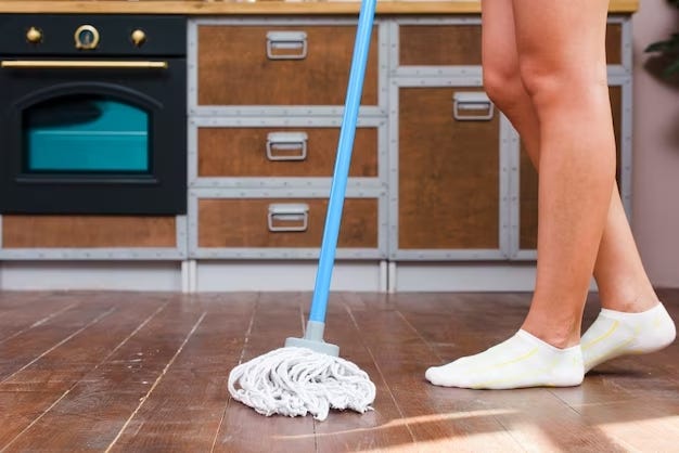 A person mopping the luxury vinyl tiles