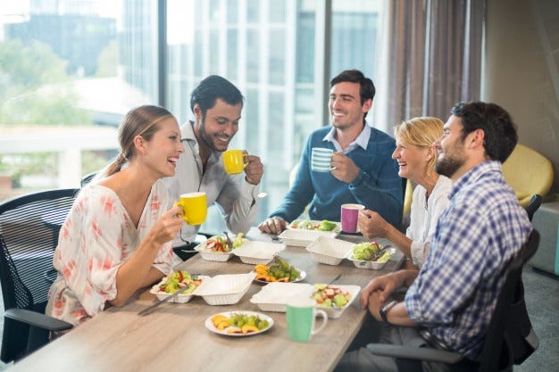 Co-workers having healthy snacks