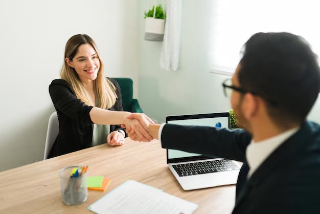 Insurance agent shaking hands with his client