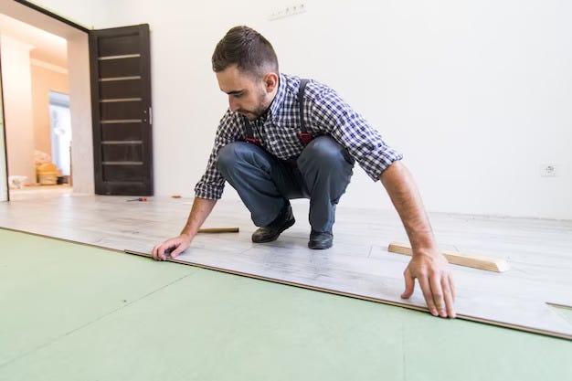 A man installing luxury vinyl tiles