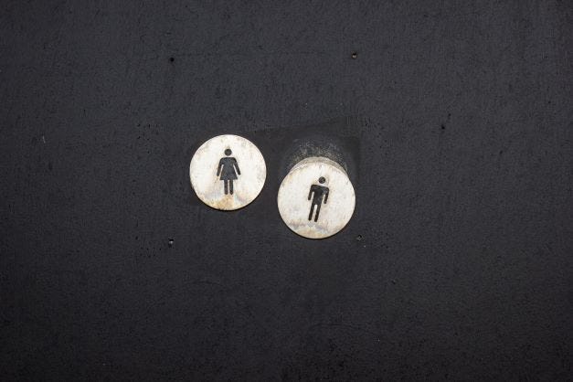 Classic gender symbols of female and male in white circles on a black background