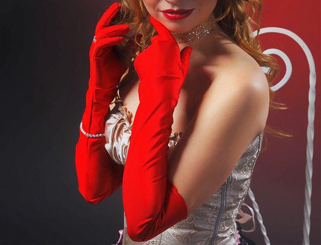 A woman wearing long red gloves