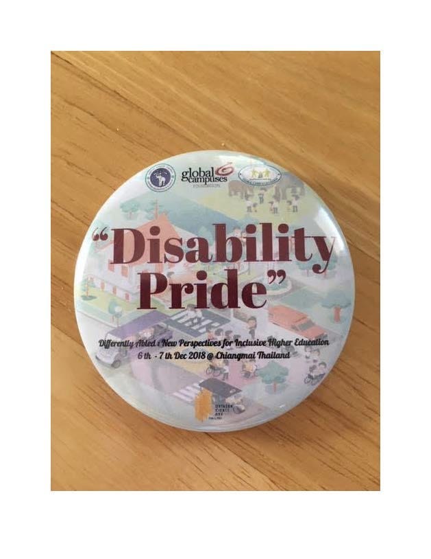 Photo of a button created by Global Campus Chang Mai that says, in bright red letters: “Disability Pride .” Photo by Author.