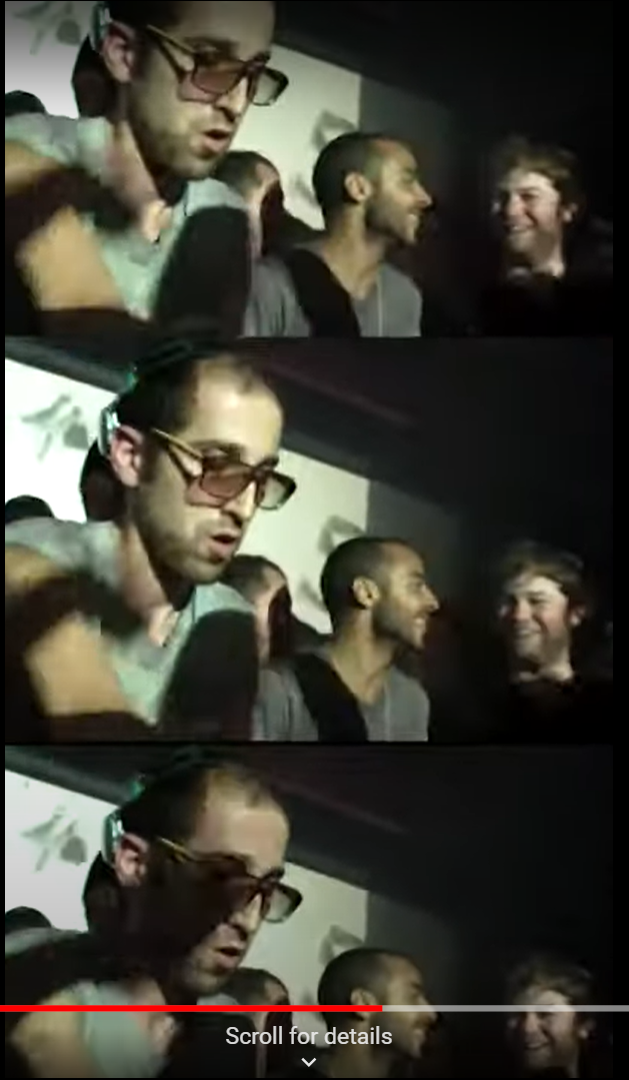 An image of a rave it is dark with many people around in a club with lights flashing and Thomas Bangalter a thin man with glasses wears headphones as he DJ’s for the club goers around.