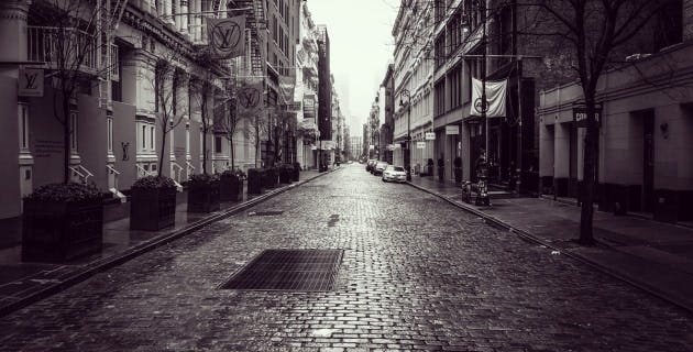 A black and white image of an empty street in Soho, New York during COVID-19
