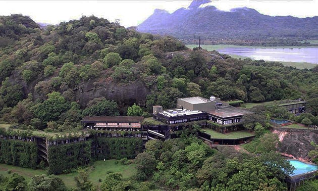 Arial view of hotel Kandalama which seems to be almost disappear into the surrounding mountain and the jungle which is full of greenery.