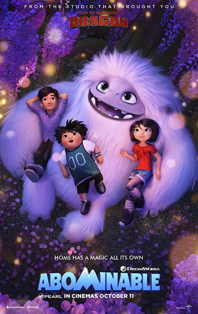 A movie poster for “Abominable”. Three children nestle against a large baby yeti and gaze up at a glowing tree. Poster text reads: Home has a magic all its own.