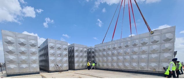 An image showing the third difference between stainless steel water storage tanks vs. concrete tanks that is of mobility