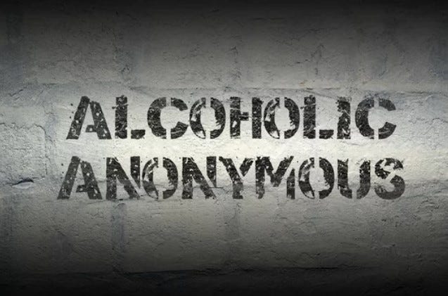 A brick wall with the words “Alcoholics Anonymous” written on it, symbolizing support and recovery.