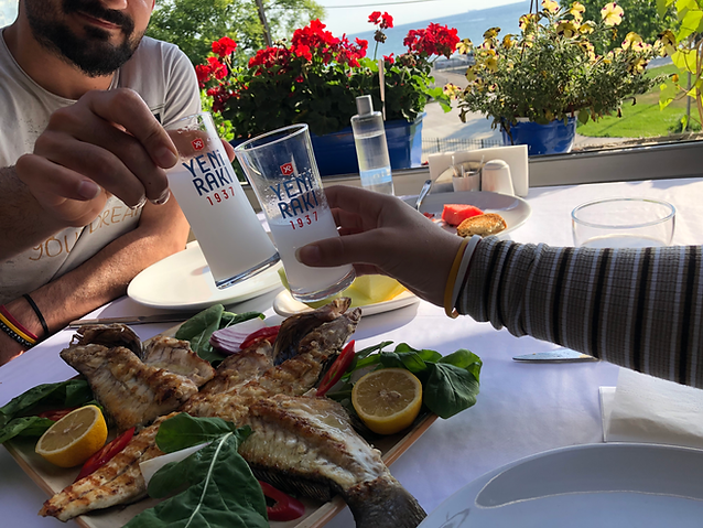 Cheers over raki and grilled seabass