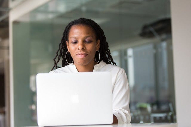 A lady working remotely on her laptop.