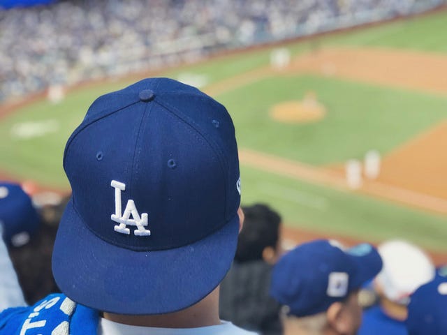 Spectator with an LA Dodgers hat watches the game at Dodger Stadium
