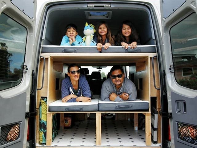 Dan and Marlene Lin with their three kids in their camper van.