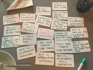 thoughts on joy in service - handwritten cards on cafe table