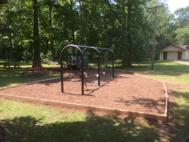 Medford Park after Ryan Minshall and his team installed a wooden retaining wall around the playground.
