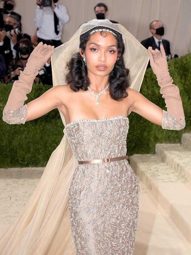 Yara Shahidi in a sleeveless Dior gown at the entrance of the Met.