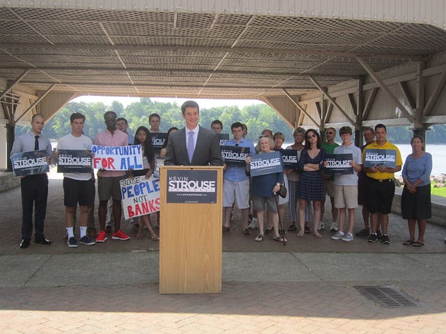LEAYANA BRINKLEY / WIRE PHOTO Kevin Strouse speaks during a news conference held last week at Bristol Borough Waterfront Park. Strouse, the Democratic candidate in the 8th Congressional District, called on Republican Rep. Mike Fitzpatrick to pledge never to become a lobbyist. 