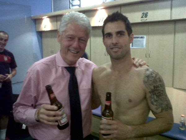 Bill Clinton and Carlos Bocanegra drinking beers