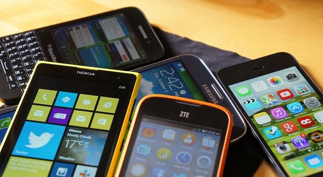 Several cellphones on a desk | Device Fragmentation | Device Intelligence