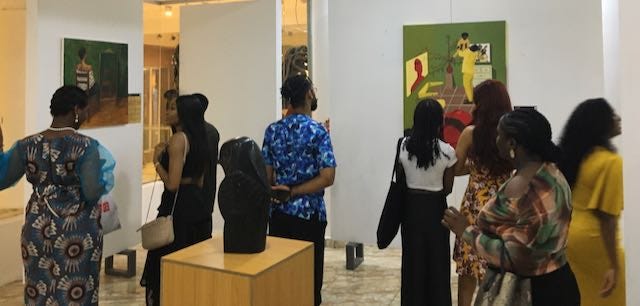 Art enthusiasts observing the Life and Times exhibition at Orisun Gallery