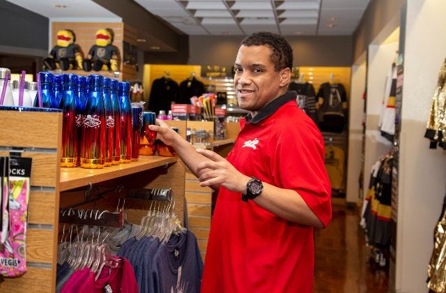 person standing in front of a retail merchandise shelf in a store