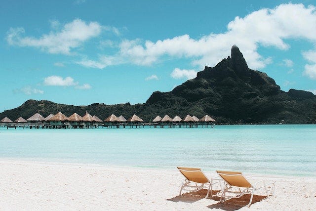 A beach with a couple of beach chairs