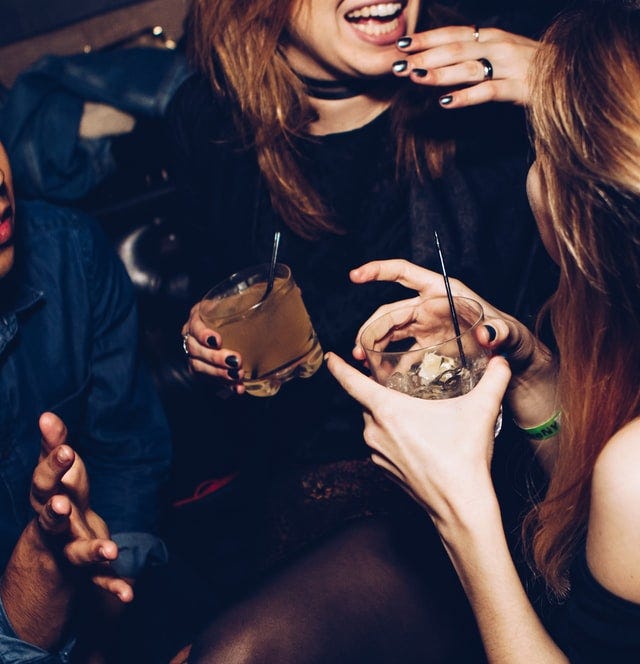 Women drinking and talking at a club