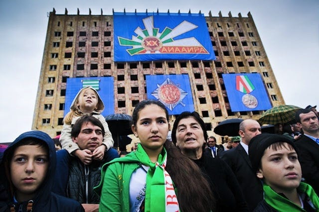 People in front of the abandoned Council of Ministries building in Sukhumi, Abkhazia.