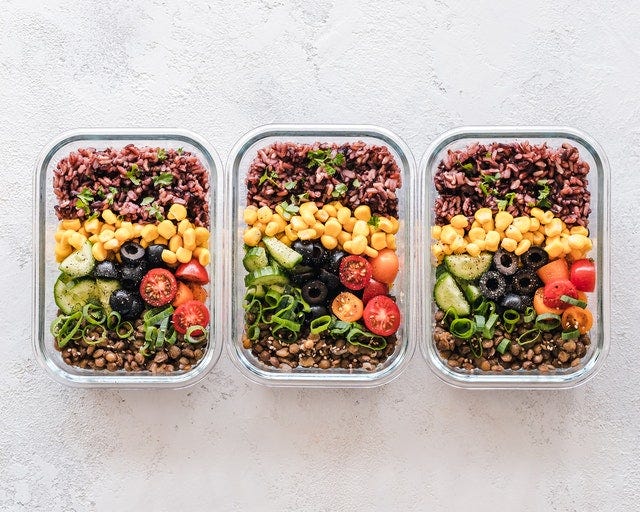 Three bowls prepared with food for meal planning