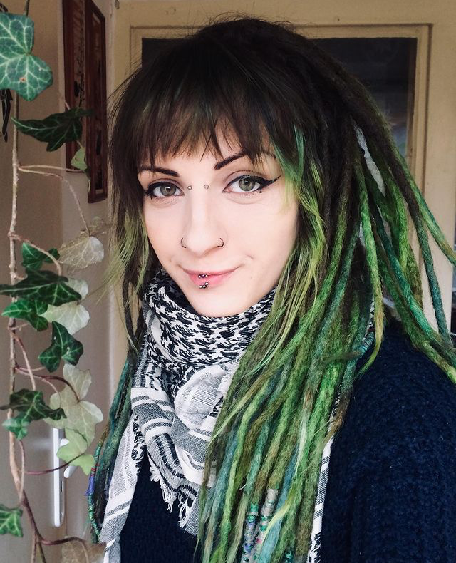 Alternative girl with piercings and green dreads