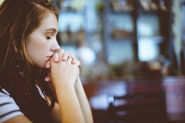 Photo of woman in deep thought and eyes closed