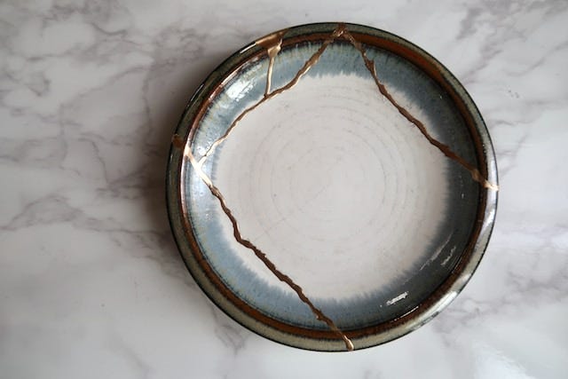 A broken plate repaired with gold in the Japanese Kintsugi style