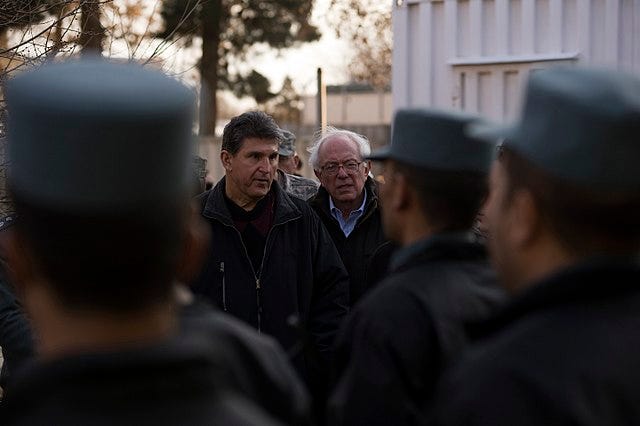 Bernie Sanders and Joe Manchin looking at students at the Afghan National Police Academy in 2011