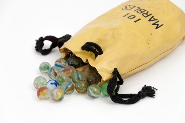 Marbles coming out of a yellow bag