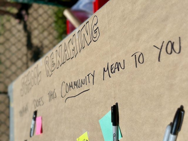 Sharpie writing on butcher block paper that reads “School Renaming” What does this community mean to you?” and some un filled out sticky notes.