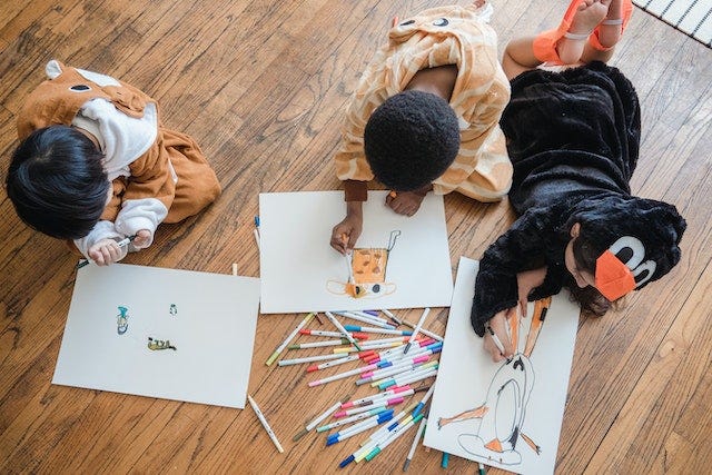 Children drawing to depict creativity.