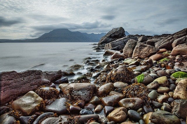 Beach in Scotland, wild looking rocky shore and overcast sky