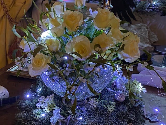 Roses and lights on the Christmas Table