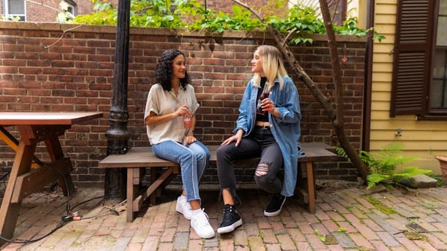 Two women talking privately