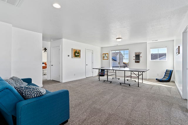 Spacious loft area of a Layton Utah Two-Storey Home filled with natural lights and lots of customizable space…