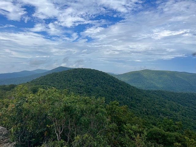 Green hills under blue skies.