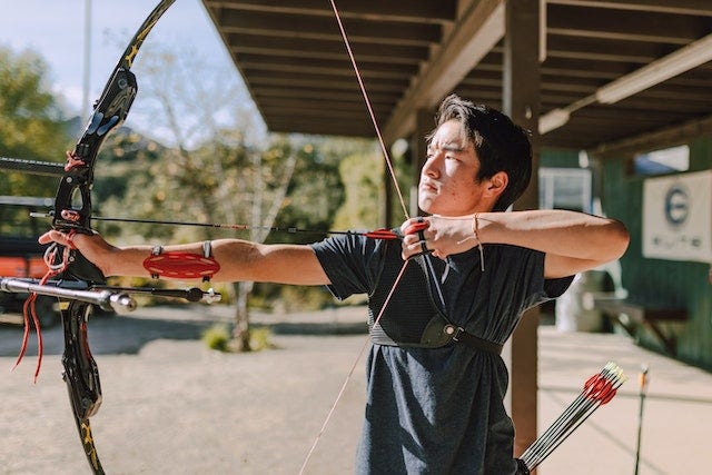 A male archer aiming a target. (Photo source: Pexels.com)
