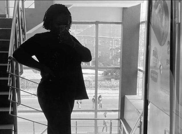 A silhouette mirror selfie of myself standing beside a stairway