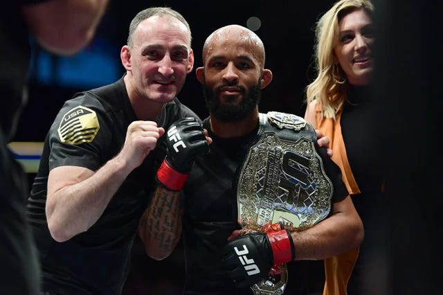 Matt Hume (left) with Demetrious ‘Mighty Mouse’ Johnson, after a successful title defense.